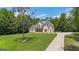 Beautiful home with a well-maintained lawn and long driveway leading to a serene property at 140 Olivia Ct, Fayetteville, GA 30215
