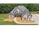 Gorgeous residence boasting a manicured front yard, stone accents, and a welcoming entrance at 140 Olivia Ct, Fayetteville, GA 30215