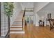 Elegant foyer with hardwood floors, a grand staircase, and natural light filling the space at 140 Olivia Ct, Fayetteville, GA 30215