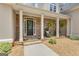 Charming front porch featuring a stone exterior, rocking chairs, and a welcoming entrance at 140 Olivia Ct, Fayetteville, GA 30215
