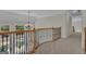 Second floor hallway with wood railings and chandelier at 140 Olivia Ct, Fayetteville, GA 30215