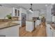 White kitchen features stone countertops, an island, stainless appliances, and glass-front cabinets at 140 Olivia Ct, Fayetteville, GA 30215