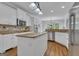 Well-lit kitchen boasts stainless steel appliances and an eat-in island at 140 Olivia Ct, Fayetteville, GA 30215