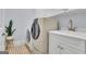 Well-lit laundry room with modern washer, dryer, sink, and ample cabinet space at 140 Olivia Ct, Fayetteville, GA 30215