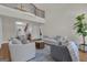 Open-concept living room boasts a balcony, comfortable seating, and hardwood floors at 140 Olivia Ct, Fayetteville, GA 30215