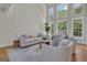 Bright living room features high ceilings, large windows, and stylish neutral furniture at 140 Olivia Ct, Fayetteville, GA 30215