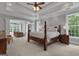 Luxurious main bedroom with tray ceilings, carpeted floors, seating area, and natural light at 140 Olivia Ct, Fayetteville, GA 30215