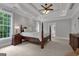 Main bedroom with tray ceilings, natural light, a four-poster bed, and carpeted floors at 140 Olivia Ct, Fayetteville, GA 30215