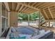 Cozy covered patio offers outdoor seating and views of the landscaped backyard with pool at 140 Olivia Ct, Fayetteville, GA 30215
