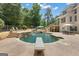 In-ground pool with diving board, waterfall feature, large patio and backyard at 140 Olivia Ct, Fayetteville, GA 30215