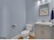 Cozy powder room includes modern vanity, gray cabinet, and hardwood floors at 140 Olivia Ct, Fayetteville, GA 30215