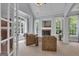 Bright sitting area with natural light from many windows, fireplace, and comfortable seating at 140 Olivia Ct, Fayetteville, GA 30215