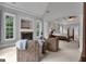 Bright and airy sitting area with fireplace, armchairs, and carpet, leading into the main bedroom at 140 Olivia Ct, Fayetteville, GA 30215