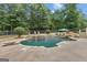 Backyard oasis featuring a private swimming pool, stone waterfall, diving board and ample seating at 140 Olivia Ct, Fayetteville, GA 30215