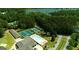 Aerial view of tennis courts and a swimming pool surrounded by beautiful green trees at 9148 Tarnwood Dr, Villa Rica, GA 30180