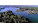 Scenic aerial view of a lakefront community surrounded by lush greenery and clear blue water at 9148 Tarnwood Dr, Villa Rica, GA 30180