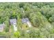 An aerial view of the home's location on a lot surrounded by mature trees and lush landscapes in a lovely neighborhood at 9148 Tarnwood Dr, Villa Rica, GA 30180