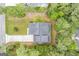 Aerial top down perspective showcasing the home's roof, driveway, and the surrounding dense foliage on the property at 9148 Tarnwood Dr, Villa Rica, GA 30180