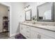 Bathroom featuring double sink vanity, granite countertop, framed mirrors and wood look flooring at 9148 Tarnwood Dr, Villa Rica, GA 30180