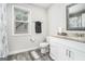 Bright bathroom featuring a vanity, a mirror, and natural light from the window at 9148 Tarnwood Dr, Villa Rica, GA 30180