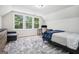 Inviting bedroom featuring a cozy bed, large windows, and a dedicated workspace area at 9148 Tarnwood Dr, Villa Rica, GA 30180