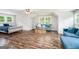 Bright open bedroom featuring stylish sofas and hardwood floors at 9148 Tarnwood Dr, Villa Rica, GA 30180