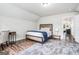 Bedroom featuring a comfortable bed, side table, study desk and views into the living space at 9148 Tarnwood Dr, Villa Rica, GA 30180