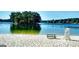 View of the sandy beach and lake. Community amenity offers residents a beach, lifeguard station, and benches at 9148 Tarnwood Dr, Villa Rica, GA 30180