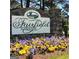 Fairfield Plantation community sign surrounded by beautiful landscaping including purple and yellow flowers at 9148 Tarnwood Dr, Villa Rica, GA 30180