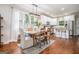 Elegant dining area featuring a modern chandelier, white cabinetry, and stainless-steel appliances at 9148 Tarnwood Dr, Villa Rica, GA 30180