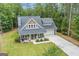 Beautiful two-story home featuring a covered front porch, manicured lawn, and a spacious driveway leading to a two-car garage at 9148 Tarnwood Dr, Villa Rica, GA 30180