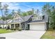 A well-manicured lawn and long driveway lead up to the pleasing facade of this home at 9148 Tarnwood Dr, Villa Rica, GA 30180