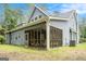 Exterior view of home showing the screened porch, siding and surrounding landscape at 9148 Tarnwood Dr, Villa Rica, GA 30180