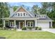 Charming home featuring a welcoming front porch with rocking chairs and well-manicured landscaping at 9148 Tarnwood Dr, Villa Rica, GA 30180