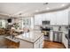 Modern eat-in kitchen with stainless appliances, white cabinets, granite countertops and dining area with table at 9148 Tarnwood Dr, Villa Rica, GA 30180