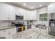 Bright kitchen features white cabinets, stainless appliances, subway tile backsplash and granite countertops at 9148 Tarnwood Dr, Villa Rica, GA 30180