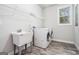 A practical laundry room with a utility sink, washer, dryer, and plenty of storage at 9148 Tarnwood Dr, Villa Rica, GA 30180