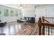 Upstairs living room boasts hardwood floors, ample natural light, modern furniture, and a stair railing at 9148 Tarnwood Dr, Villa Rica, GA 30180