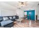 Bright living room with a plush sectional sofa, stylish coffee table, and access to the stairway at 9148 Tarnwood Dr, Villa Rica, GA 30180