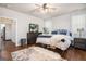 Bright main bedroom offers hardwood floors, a ceiling fan, ample natural light and a walk-in closet at 9148 Tarnwood Dr, Villa Rica, GA 30180