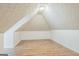 Finished attic space with wood-look floors, bright white walls, and interesting ceiling details at 3797 Churchill Sw Dr, Marietta, GA 30064