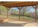 Covered back patio offers an outdoor living space with a brick floor and views of the backyard and trees at 3797 Churchill Sw Dr, Marietta, GA 30064