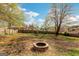 Spacious backyard featuring a fire pit, mature trees, and a privacy fence, perfect for outdoor enjoyment at 3797 Churchill Sw Dr, Marietta, GA 30064