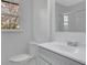 Bright bathroom featuring a toilet, vanity with sink, and shower with glass door, all in a clean, modern design at 3797 Churchill Sw Dr, Marietta, GA 30064