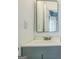 Bathroom featuring a gray vanity and sink, a mirror, and an electrical outlet at 3797 Churchill Sw Dr, Marietta, GA 30064