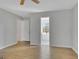 Bedroom with wood-look flooring and an open doorway to the bathroom with a large soaking tub at 3797 Churchill Sw Dr, Marietta, GA 30064