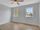 Bedroom featuring wood-look floors, ceiling fan, and two windows providing ample natural light at 3797 Churchill Sw Dr, Marietta, GA 30064