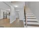 Inviting entryway with hardwood floors, a staircase with black iron spindles, and an open view into the kitchen at 3797 Churchill Sw Dr, Marietta, GA 30064