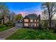 Dusk shot of a beautiful two-story home featuring a brick facade, attached garage, and illuminated interior at 3797 Churchill Sw Dr, Marietta, GA 30064