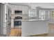 Modern kitchen with white cabinets, stainless steel appliances, granite countertops, and a kitchen island at 3797 Churchill Sw Dr, Marietta, GA 30064